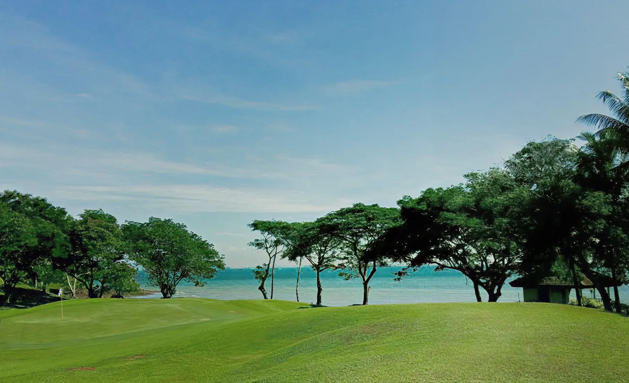Aerial view of a golf course beside the ocean